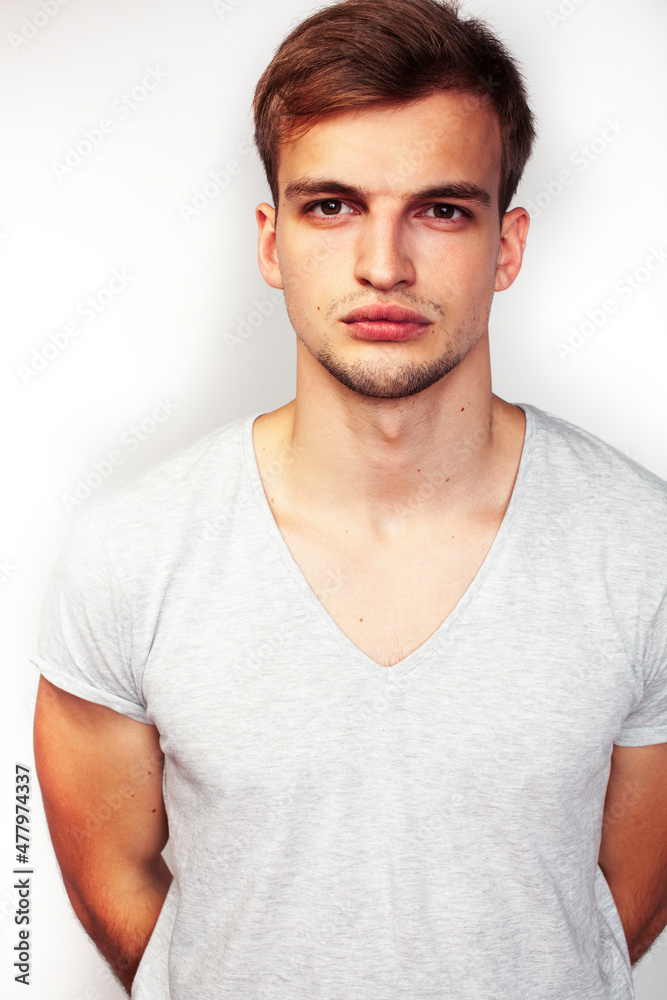 Obraz premium young handsome teenage hipster guy posing emotional, happy smiling against white background isolated, lifestyle people concept