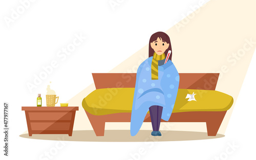 The sick girl wrapped herself in a blanket with a thermometer.