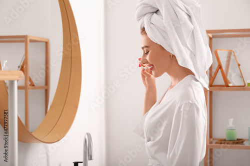 Pretty young woman brushing...