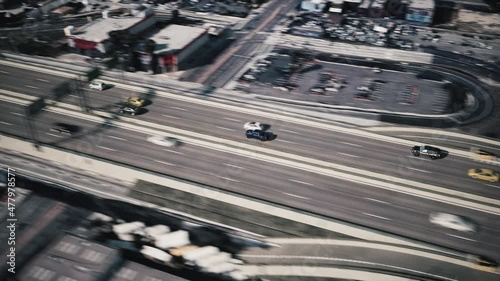The highway patrol is chasing the fast vehicle. Police helicopter pursuit the car. Police Highway Chase. Aerial view of police pursuit. 3d animation  photo