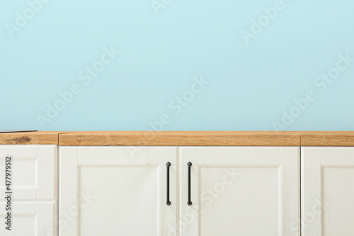 white wooden counters near blue wall