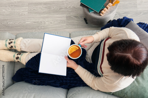 Woman with cup of tea sitti...