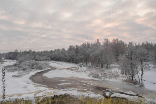 Aerial view of beautiful frozen Jagala (Estonian - Jägala) river on a cloudy winter morning. Estonia.