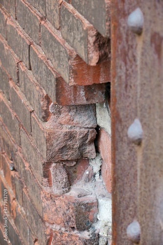 broken bricks at industrial factory wall