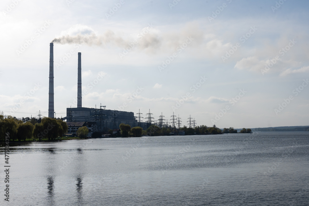 Panoramic view of power station Lukomlskaya Gres. Chimneys with smoke of power plant. Ecological problem. Environmental pollution concept. Panoramic view of power station Lukomlskaya Gres. Chimneys with smoke of power plant. Ecological problem. Environmental pollution concept.