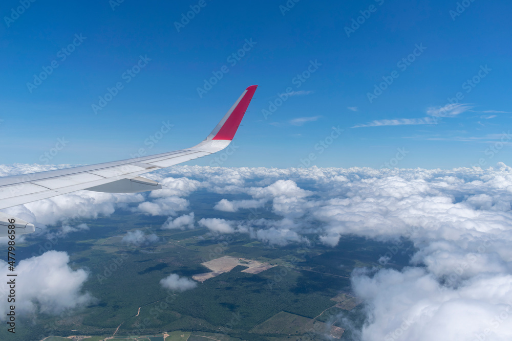 image of airplane window with sky and clouds image of airplane window with sky and clouds