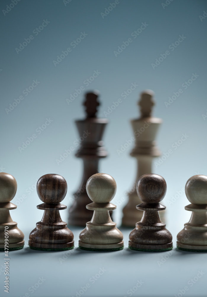 Black and white chess teams standing together Black and white chess teams standing together
