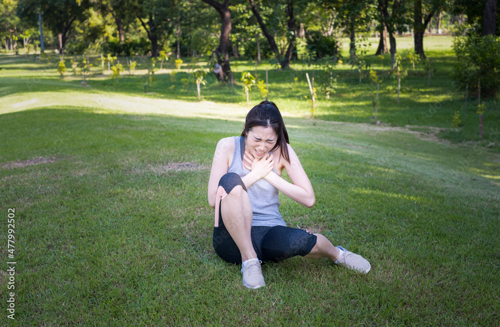 Young female have chest pain while running in the park. Young woman