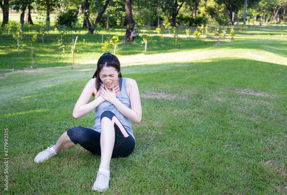 Young female have chest pain while running in the park. Young woman