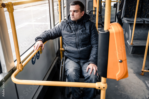 Person with a physical disability inside public transport with an accessible ramp.