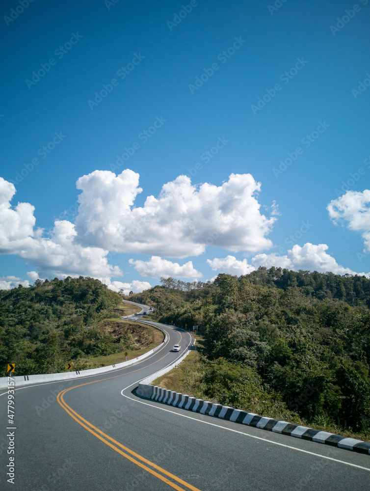seamless aerial view of cars driving on curved, zigzag curve road or street on mountain hill