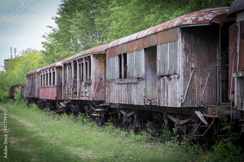 Old and abandoned train wagons in a forest at a lost place railway station in austria