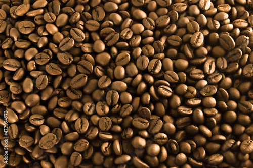 Golden coffee, background texture, close-up. Shiny arabica grains photo