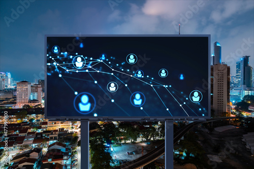 Glowing Social media icons on billboard over night panoramic city view of Kuala Lumpur, Malaysia, Asia. The concept of networking and establishing new connections between people and businesses in KL photo