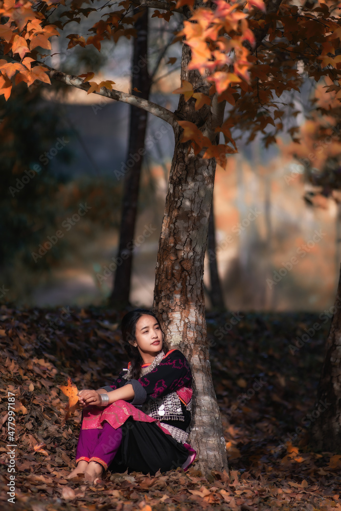 Lisu woman sitting under a maple tree Lisu woman sitting under a maple tree