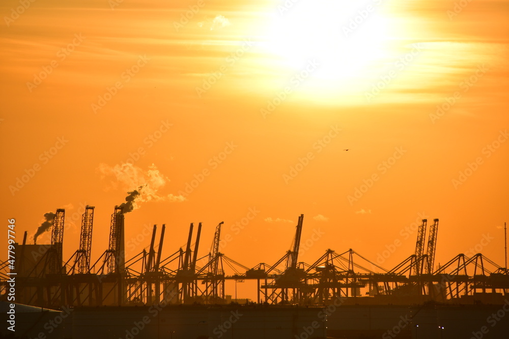 Sunset harbour - including cranes and other port machinery