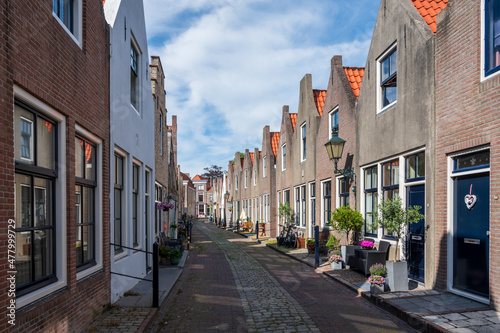 Walking in old Dutch town Zierikzee with old small houses and streets photo
