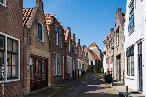 Walking in old Dutch town Zierikzee with old small houses and streets