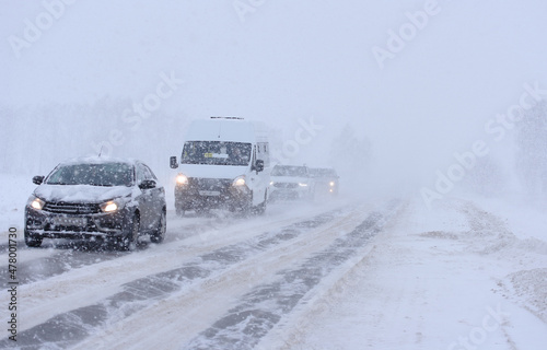 The movement of vehicles on the road in heavy snowfall