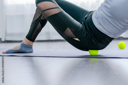 Woman use Myofascial release massage balls on hip selective focus