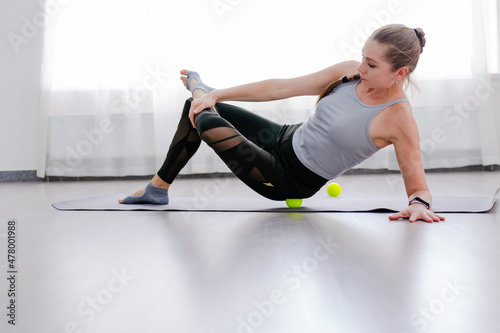 Woman use Myofascial release massage balls on hip selective focus