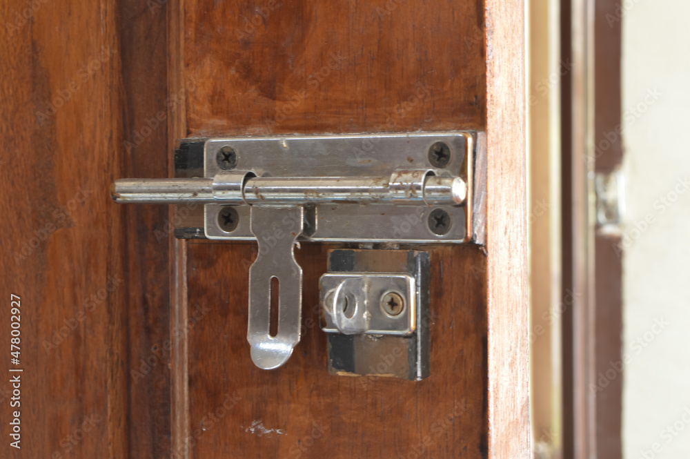 Close up view of wooden door with slide bolt lock. Close up view of wooden door with slide bolt lock.