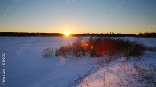 Winter time lapse of sunset over the frozen lake