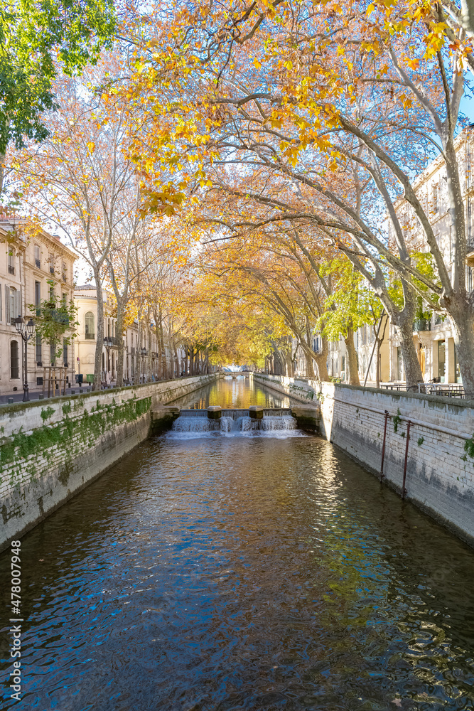 Nimes in France, old facades in the historic center, with a canal quai de la Fontaine
