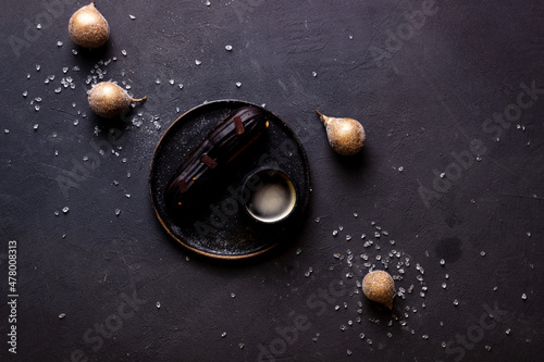 still life with eclairs on a dark background