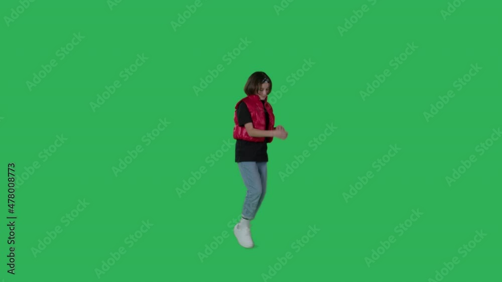 young beautiful girl dancing hip hop, dancehall, street dance over green screen background. Happy smiling child having fun on Chroma Key. 4k uhd video footage young beautiful girl dancing hip hop, dancehall, street dance over green screen background. Happy smiling child having fun on Chroma Key. 4k uhd video footage