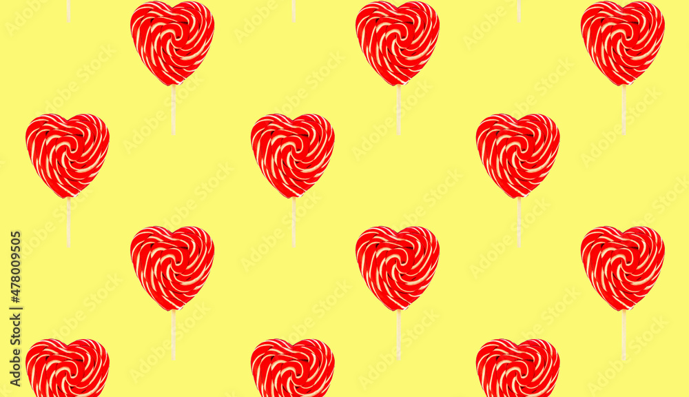 Red heart lollipops pattern on yellow background love and Valentine day background Red heart lollipops pattern on yellow background love and Valentine day background