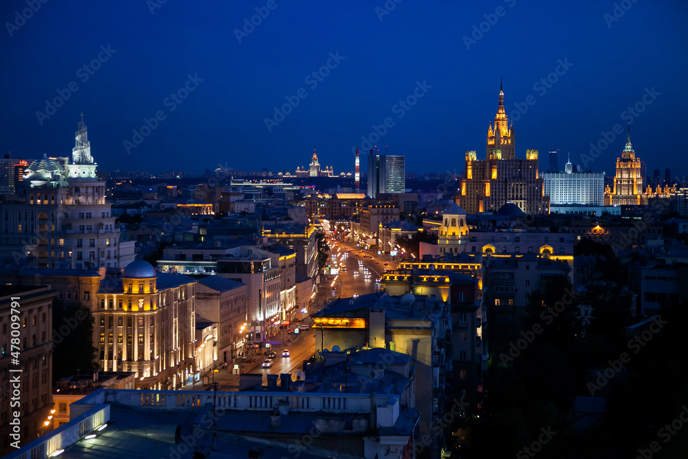 Panorama of evening or night illuminated building of Moscow Garden Ring. Famous Stalinist building. Deep blue sky.