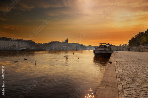 River Vltava with bridges and a boat on the surface in the city of Prague in the Czech Republic