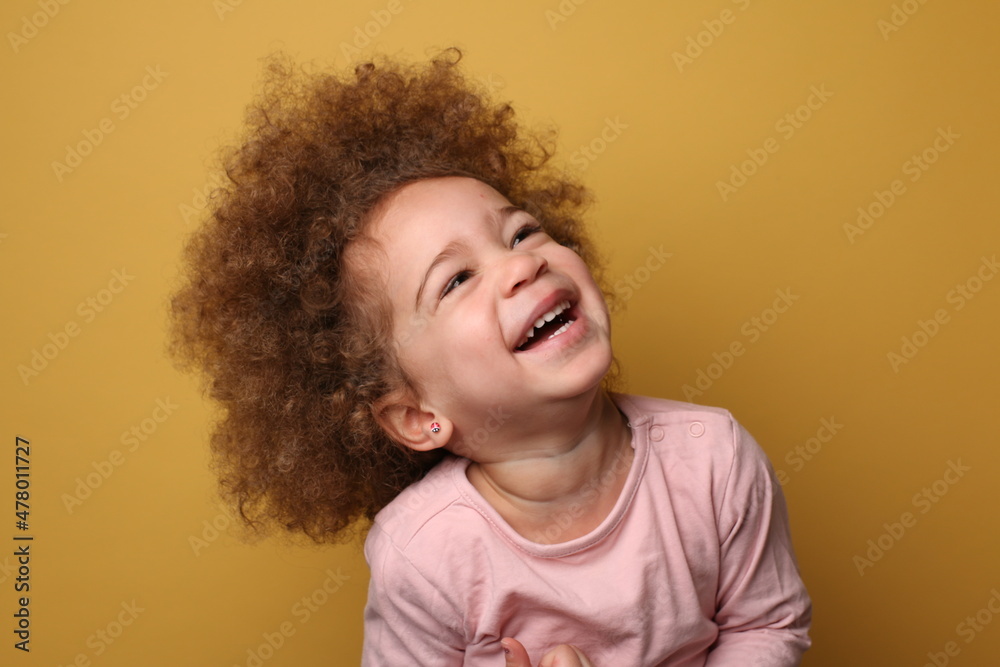 Beautiful toddler in front of a colored background Beautiful toddler in front of a colored background
