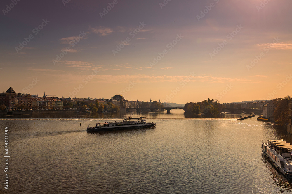 River Vltava in the city of Prague with bridges and a boat on the surface