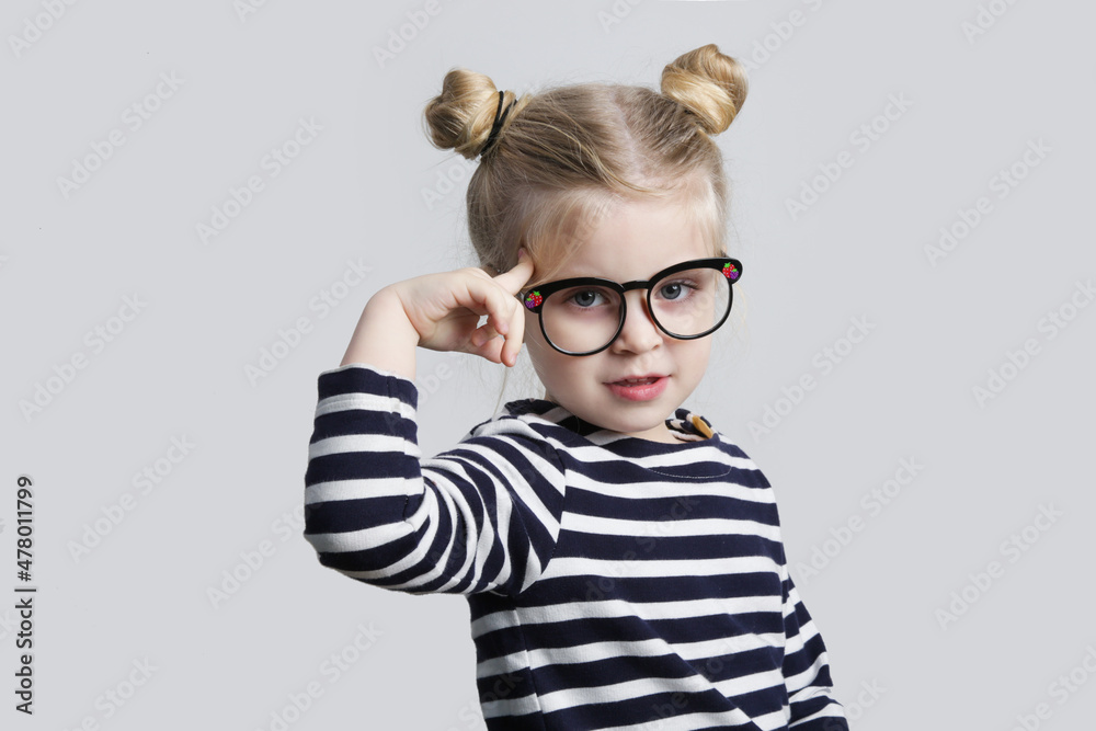 Little nerd pointing finger to her head, studio shot