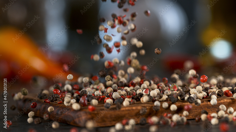Freeze Motion Shot of Crushing Colored Peppers Balls in Mortar. Freeze Motion Shot of Crushing Colored Peppers Balls in Mortar.