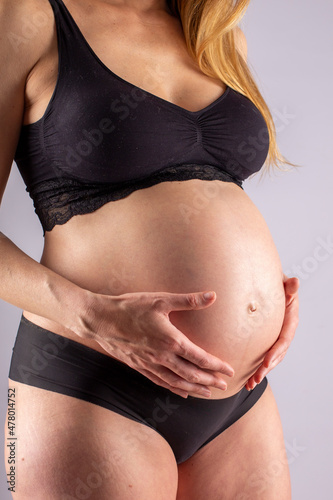 Normal pregnant woman with more than 35 years and 8 months of gestation. Black underwear.