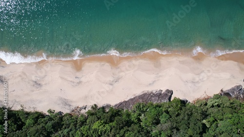 Beautiful deserted beach in Ubatuba, São Paulo, Brazil. Atlantic forest, yellow sand and clear sea water. Figueira beach paradise.