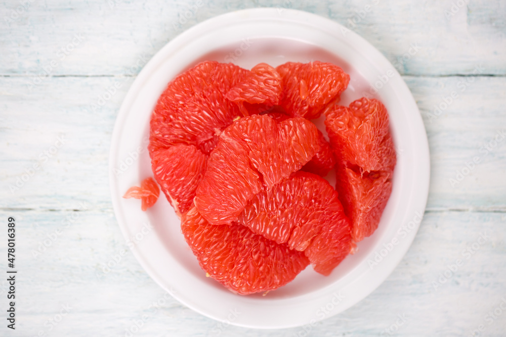 Juicy delicious ripe grapefruit on a white plate Juicy delicious ripe grapefruit on a white plate