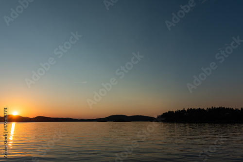 View from Saturna Island dock of silhouetted Southern Gulf Islands at sunset