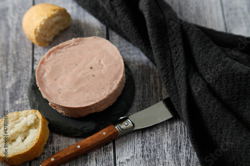 Delicious block of foie with bread on a rustic background