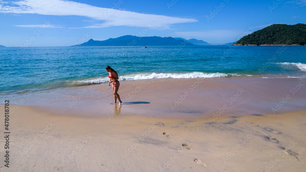 Brazilian woman in bikini on a deserted beach in Ubatuba, São Paulo, Brazil. Playing in the sea water
Atlantic forest, yellow sand and clear sea water. Figueira beach paradise.
