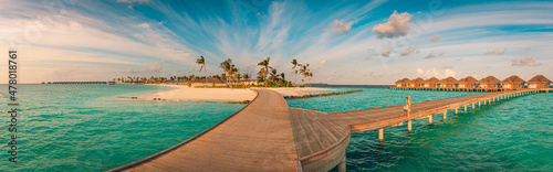 Fototapeta Naklejka Na Ścianę i Meble -  Amazing sunset panorama at Maldives. Luxury resort villas seascape with wooden bridge under colorful cloudy sky. Fantastic travel hotel landscape. Panoramic beach background for vacation holiday