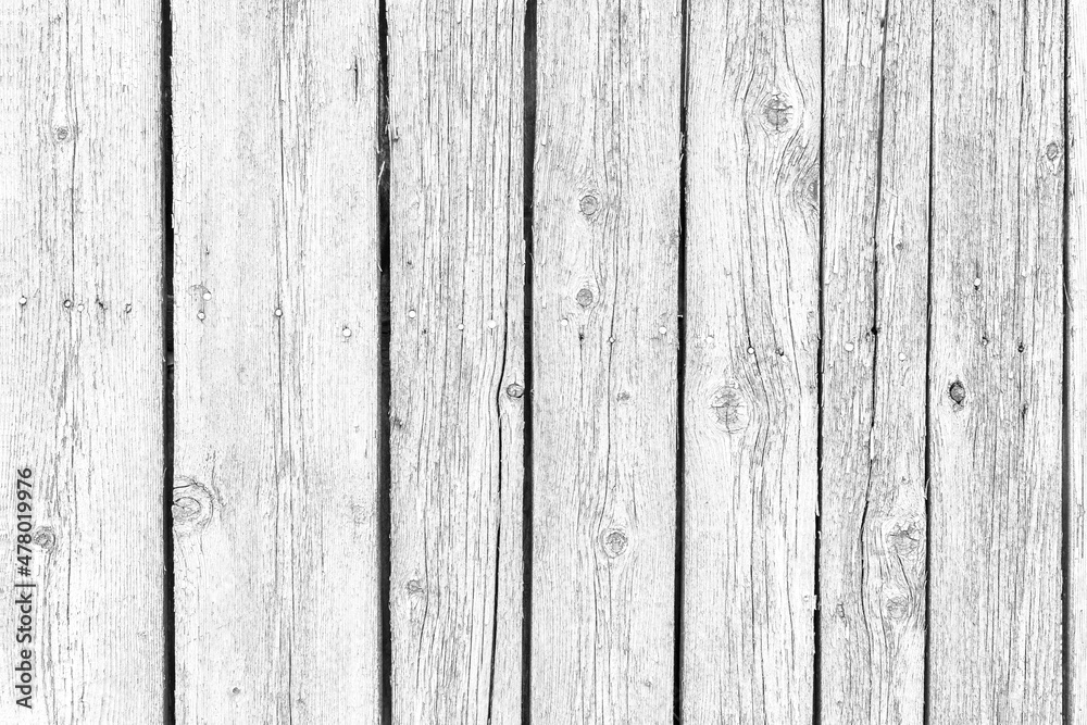 Wooden background. Old black and white painted fence in good condition. Solid wooden wall from weathered cracked boards. Barn wood wall. Wooden background. Old black and white painted fence in good condition. Solid wooden wall from weathered cracked boards. Barn wood wall.