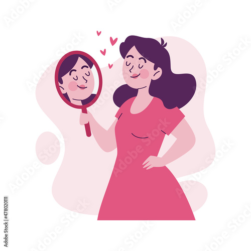 Confident woman looks at herself in the mirror