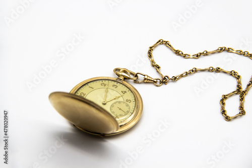 Vintage golden old pocket watch on white background.