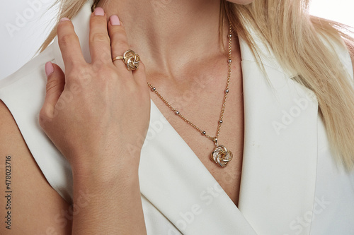 Gold necklace and ring on young lady
