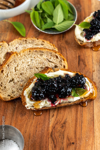 Sliced multi grain bread with cream cheese and blackberry jam photo