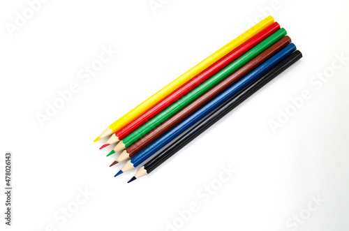Sharpened colored pencils isolated on a white background. Office supplies